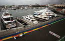 Adrian Sutil passes boats in the harbour