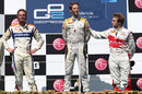 Romain Grosjean enjoys his victory on the podium with Giedo van der Garde and Davide Valsecchi
