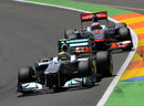 Nico Rosberg holds off Jenson Button early in the race