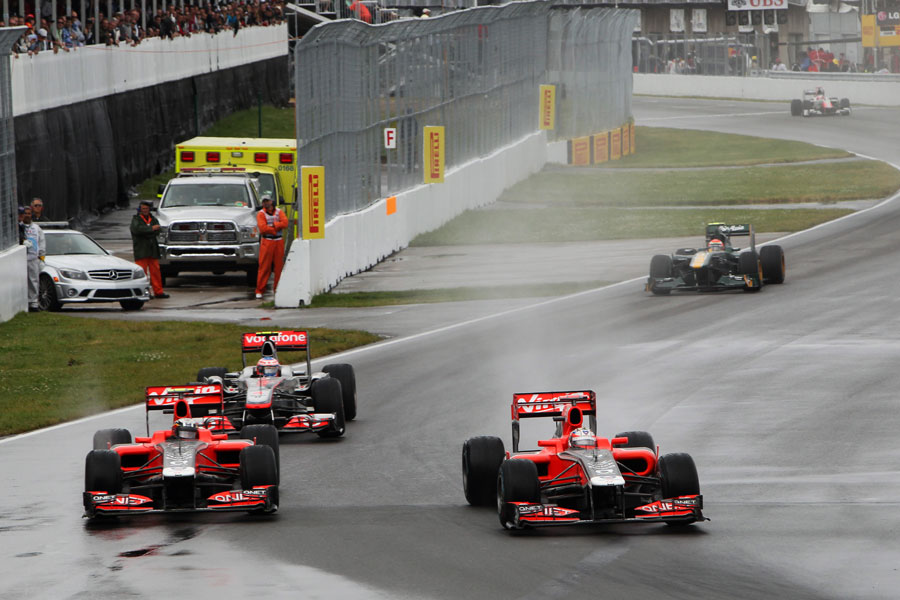 Jerome d'Ambrosio and Timo Glock battle as Jenson Button looks for a way through