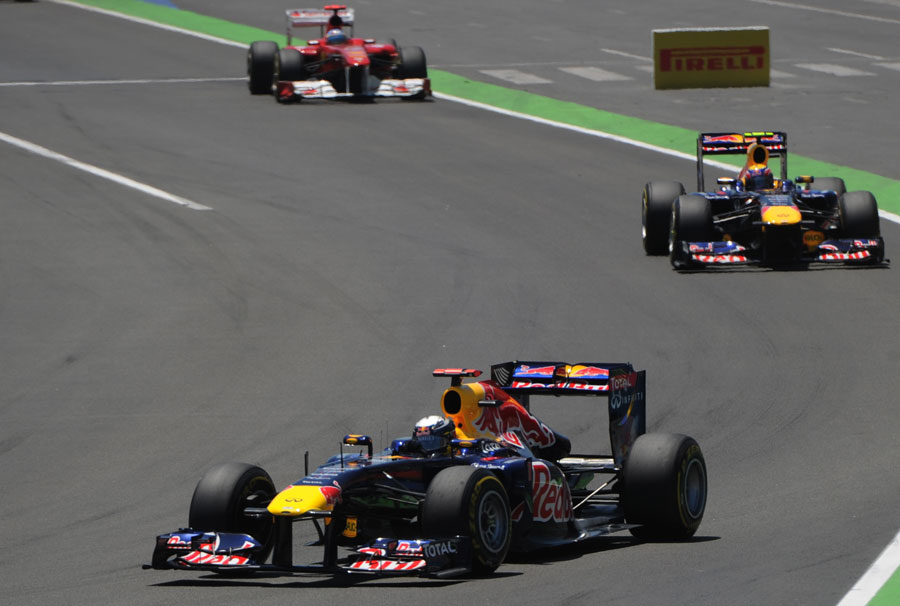 Sebastian Vettel leads Mark Webber and Fernando Alonso into turn two