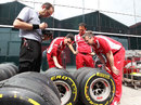 Fernando Alonso's race engineer Andrea Stella examines tyres with Ferrari technical director Pat Fry
