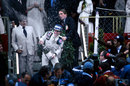 Patrick Depailler celebrates his first grand prix victory on the podium at Monaco