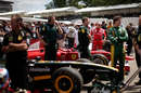 Lotus and Ferrari cars waiting to go up the hill at Goodwood