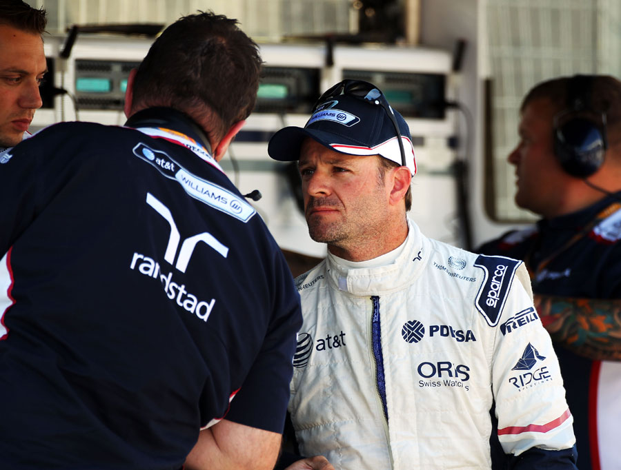 Rubens Barrichello talks to engineers on the pit wall