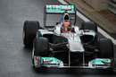 Michael Schumacher cruises down the pit lane