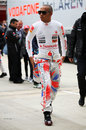 Lewis Hamilton walks down the paddock on Saturday