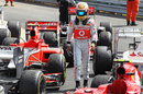 Lewis Hamilton walks back past some very worn tyres