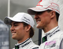 Michael Schumacher and Nico Rosberg pose for photos in the rain