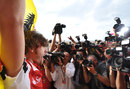 Fernando Alonso celebrates his first win of 2011 in front of a scrum of photographers