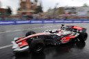 Jenson Button drives past St. Basils cathedral during the 'Moscow City Racing' show