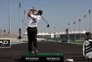 Golfer Sergio Garcia tees off on the start-finish straight at the Abu Dhabi Grand Prix circuit