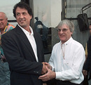 Bernie Ecclestone and Sylvester Stallone talk in the paddock