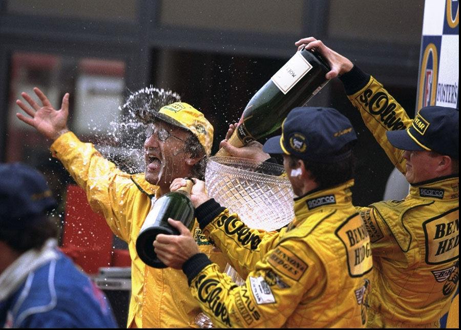 Eddie Jordan celbrates his team's first victory with Damon Hill and Ralf Schumacher