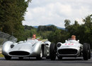 Michael Schumacher and Nico Rosberg at the wheels of a pair of Mercedes W196s on the Nordschleife