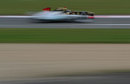 Nick Heidfeld speeds past Michael Schumacher