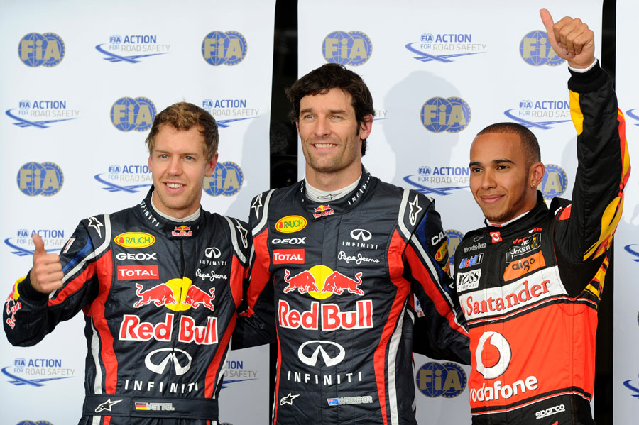 Mark Webber celebrates his pole position with Lewis Hamilton and Sebastian Vettel
