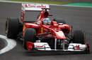 Fernando Alonso lifts a wheel through turn one