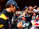 Mark Webber signs autographs after taking pole position on Saturday