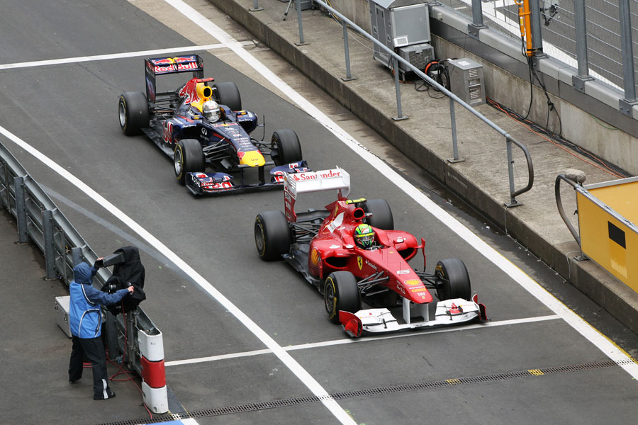 Felipe Massa leads Sebastian Vettel in for the final pit stops on the last lap