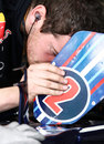 A Red Bull mechanic takes a look at Mark Webber's pedal position