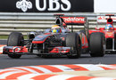 Lewis Hamilton leads Fernando Alonso through the chicane
