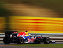 Sebastian Vettel flashes past advertising hoardings on a fast lap