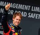Sebastian Vettel celebrates his pole position in front of the cameras