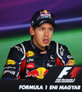 Sebastian Vettel answers questions in the press conference after taking pole