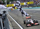 Jenson Button crosses the line to take victory