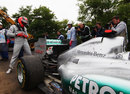 Michael Schumacher assess the rear of his Mercedes after retiring with a gearbox problem