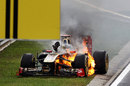 Nick Heidfeld tries to make a quick exit from his burning Renault