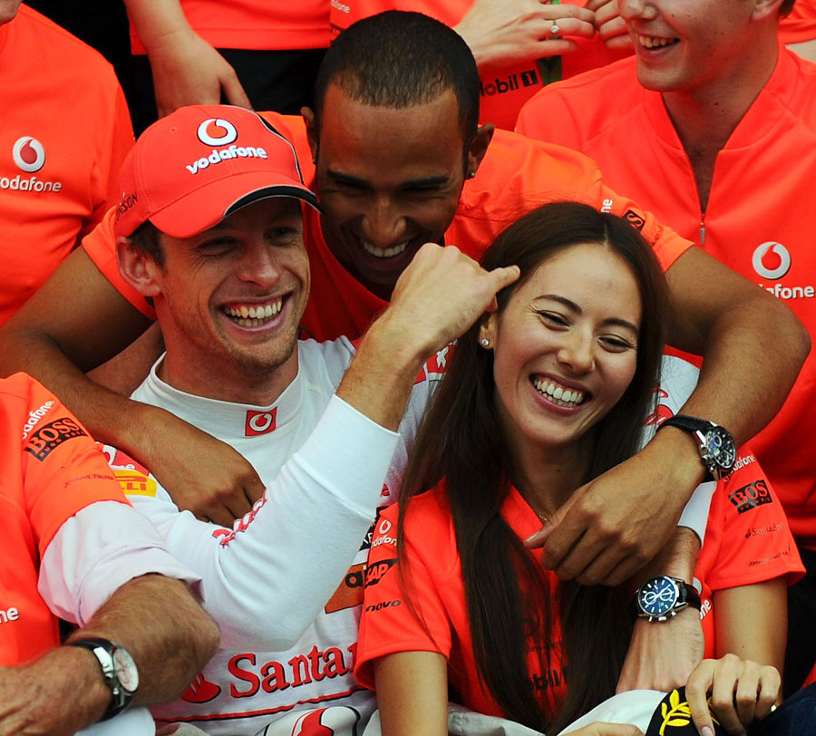 Jenson Button celebrates his victory with his girlfriend Jessica Michibata and Lewis Hamilton