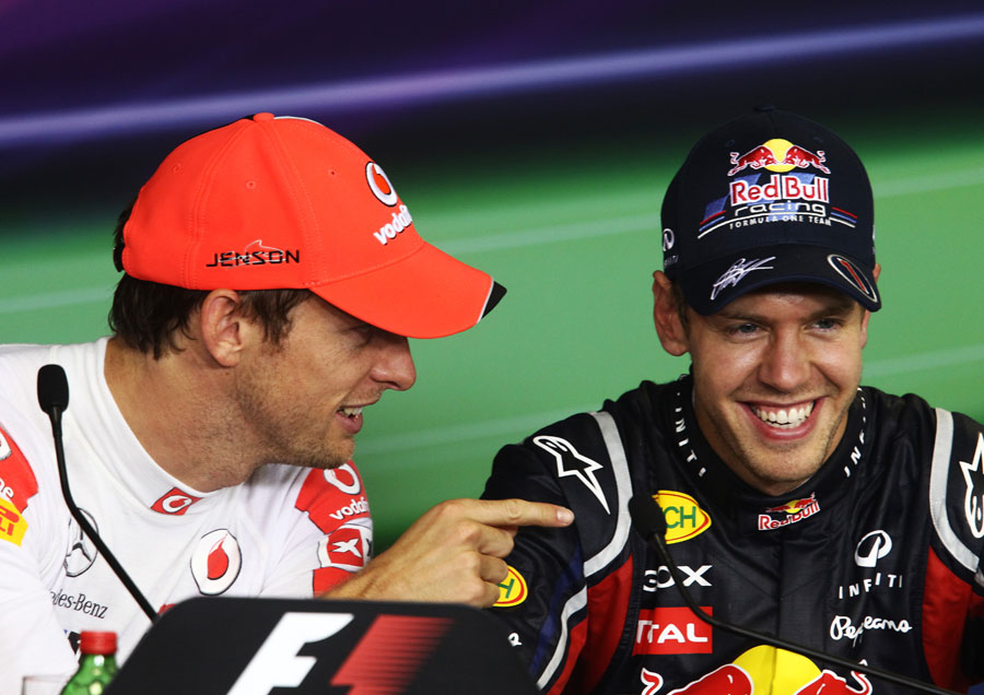 Jenson Button jokes with Sebastian Vettel in the drivers press conference