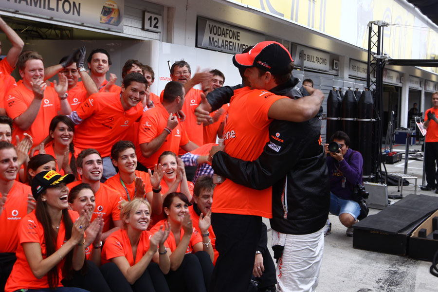 Jenson Button is congratulated on his victory by Lewis Hamilton