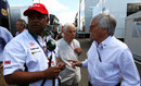 Bernie Ecclestone talks to Tony Fernandes in the paddock