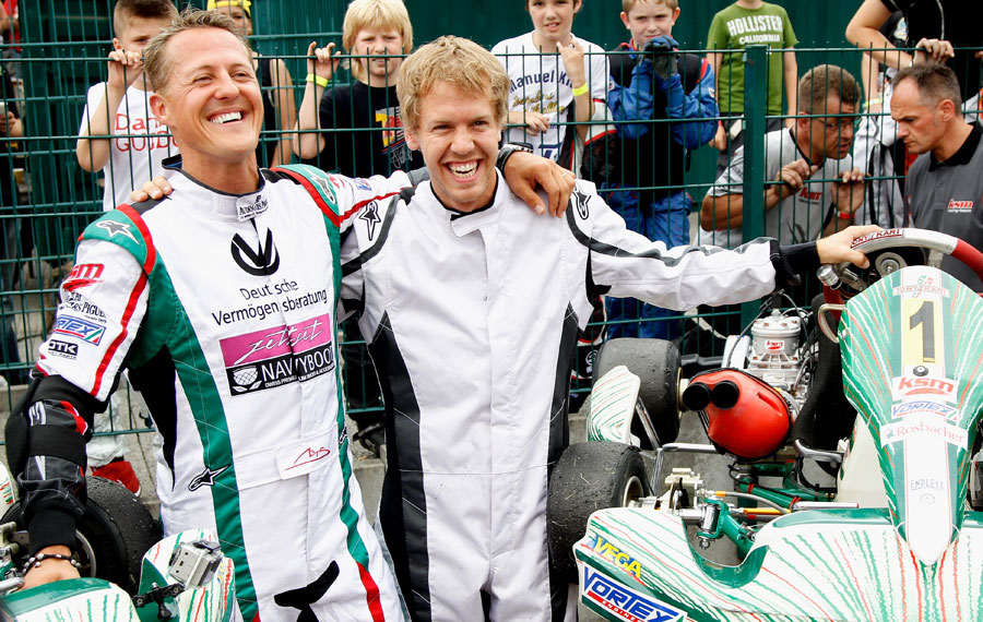 Michael Schumacher and Sebastian Vettel pose before a race to celebrate 50 years of the Kart Club Kerpen