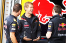 Sebastian Vettel jokes with his Red Bull mechanics