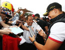 Michael Schumacher signs autographs on the 20th anniversary of his first grand prix start
