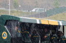 Rain lashes down on the Lotus pit wall