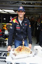 Mark Webber celebrates his 35th birthday with a cake in the Red Bull garage