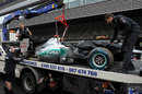 Michael Schumacher's car is towed away after his crash at the start of Q1