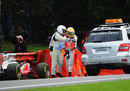 Lewis Hamilton is helped away after crashing out