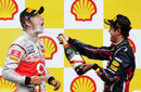 Sebastian Vettel sprays Jenson Button with champagne
