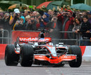 Jenson Button takes a McLaren on a demonstration run in Manchester