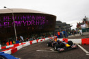 Mark Webber drives his Red Bull through the city streets of Cardiff 