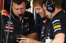 Sebastian Vettel jokes with the Red Bull mechanics