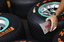 A Mercedes mechanic marks up Nico Rosberg's wet tyres