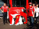 Fernando Alonso signs a model elephant painted in Ferrari colours
