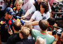 Sebastian Vettel faces a bank of TV reporters